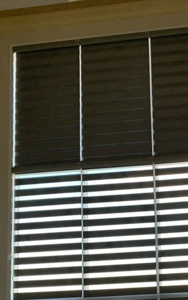 Blackout shade sealed edge to edge with side tracks in a dark Calgary bedroom