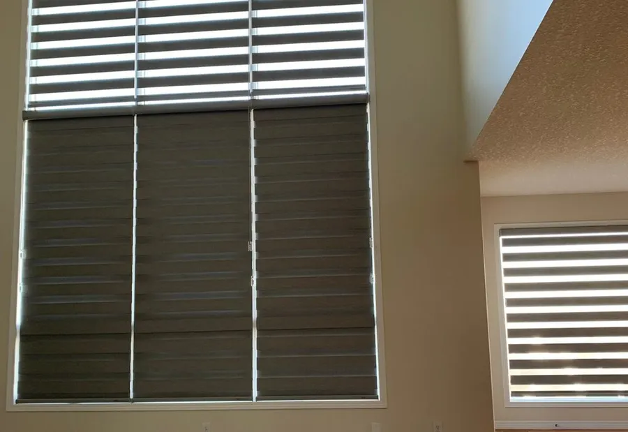 Room-darkening blackout shade lowered over a wide Calgary bedroom window