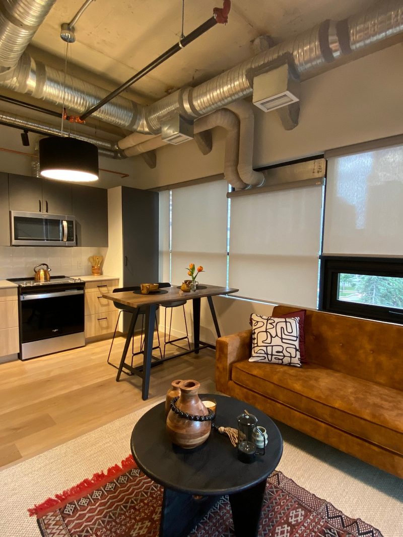 Bridgeland loft with roller shades on tall windows